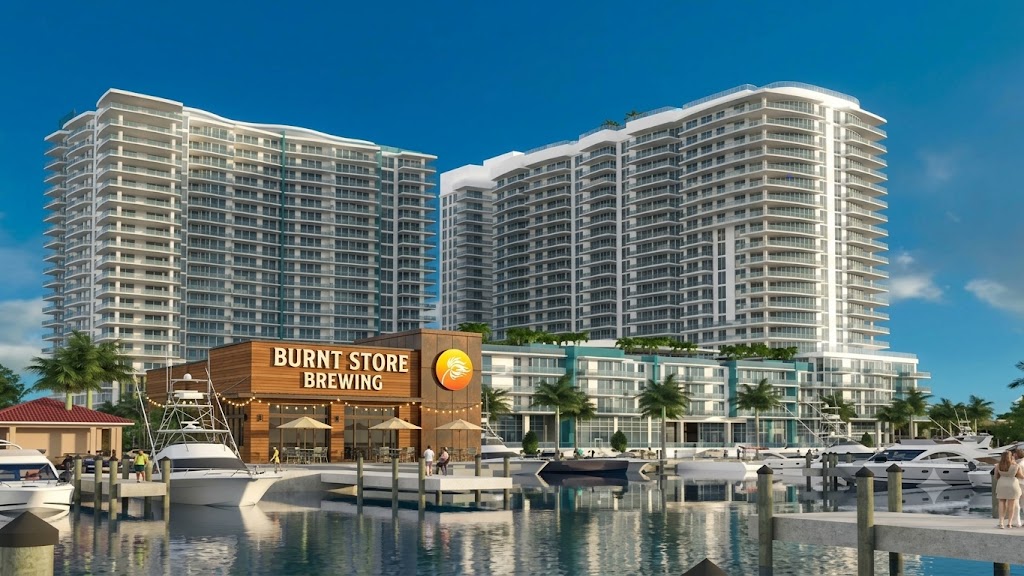 Concept mockup: a Burnt Store Brewing brewpub with wood facade, sunset palm-flame logo and waterfront patio seating, imagined into the Seven Islands marina rendering